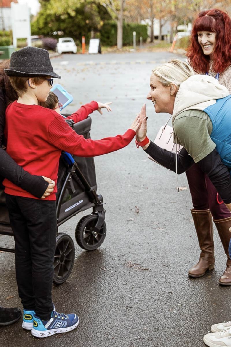 Photo of a kid talking with an woman.