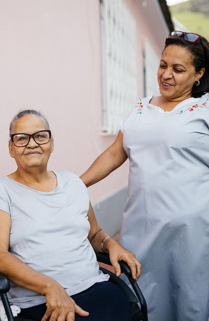 Photo of two ladies together outside in the yard.